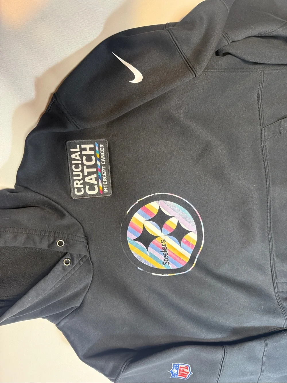 Crucial Catch Black Pullover with Multicolor Stripe Patch